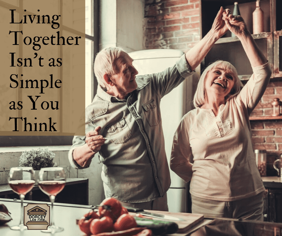 couple dancing together in kitchen with caption text "Living Together Isn’t as Simple as You Think"